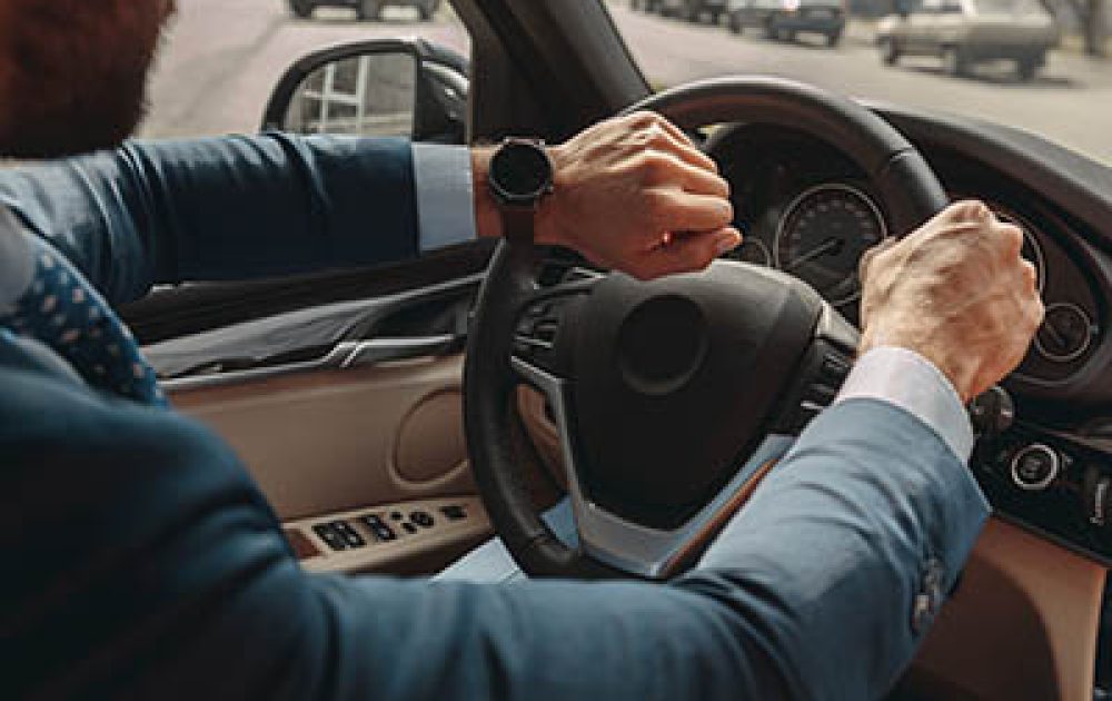 Cropped head portrait of unrecognized elegant businessman hurrying to a business meeting by automobile