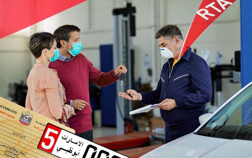 Couple with protective face masks giving car key to their auto repairman in a workshop.
